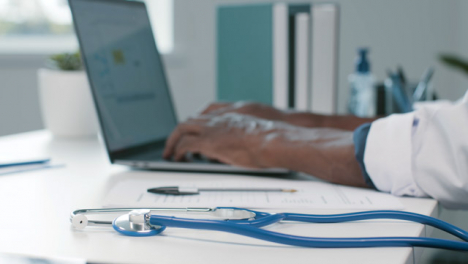 Doctor-s-Hands-at-Desk-Typing-and-Writing-Notes